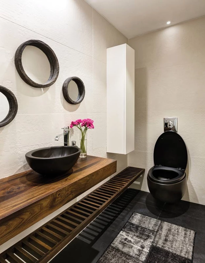 שירותי האורחים: עיצוב דרמטי: מדף אגוז גושני עם כיור בהנחה עליונה  ותחתיו מדף שלבים. חיפוי, ריצוף ואביזרים סניטאריים: