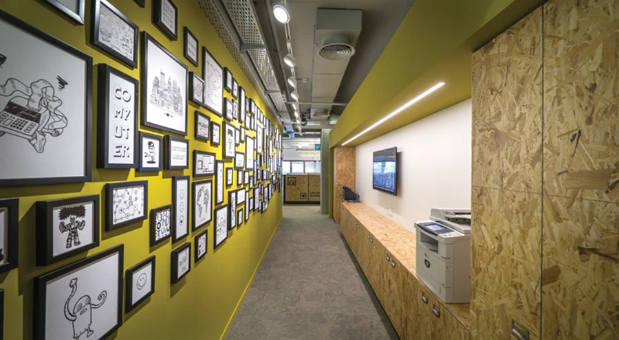 קריצה במעברבין שני עברי הקומה: קיר בצהוב עז מהווה רקע למקבצי אימג