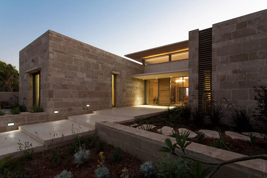 חזיתו הקדמית של הבית: שביל מדרגות המוביל אליו, שתי היחידות הקדמיות מתוך הארבע המרכיבות אותו תוחמות אותן תוך יצירת מבואה חיצונית, גג מרחף עשוי בטון לבן, והצצה ישירה לחלל הפנים ולנוף הנחשף בעומקו.