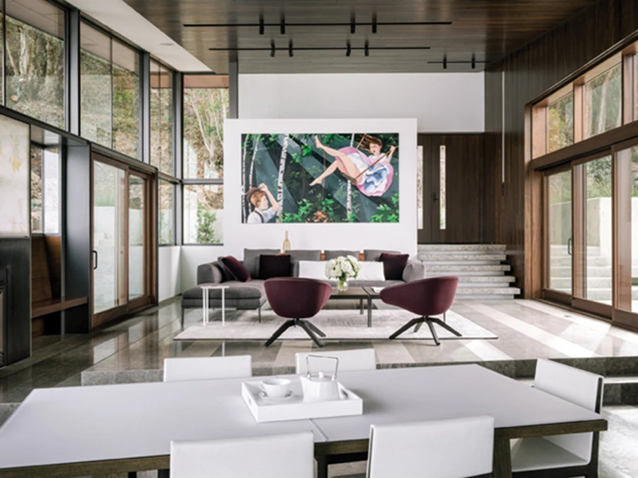 אזור הסלון שבחלל המגורים: תחום בפתחים גדולים עשויים עץ משני עבריו. ריצוף באריחי אבן ליימסטון צרפתית בשני מרקמי גימור שונים המייצרים תצורת פסים.