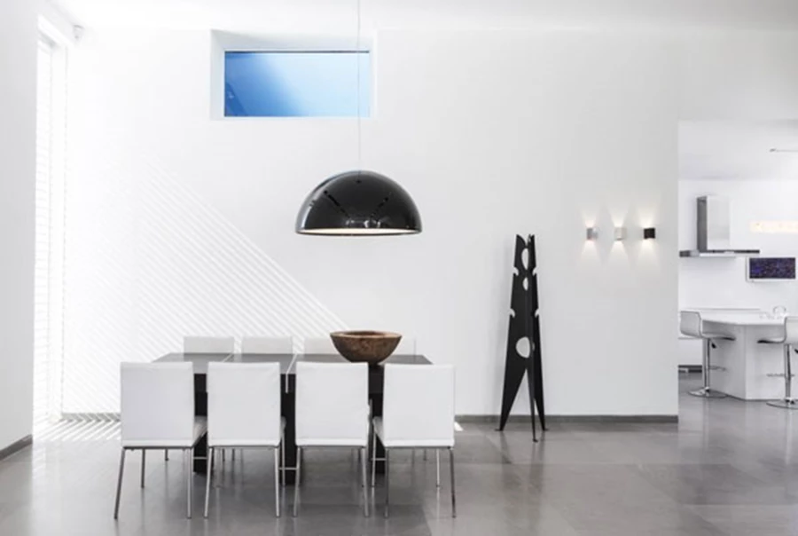 פינת אוכל בה התאורה דומיננטית מאוד ועם זאת שומרת על קו כמעט מיניליסטי