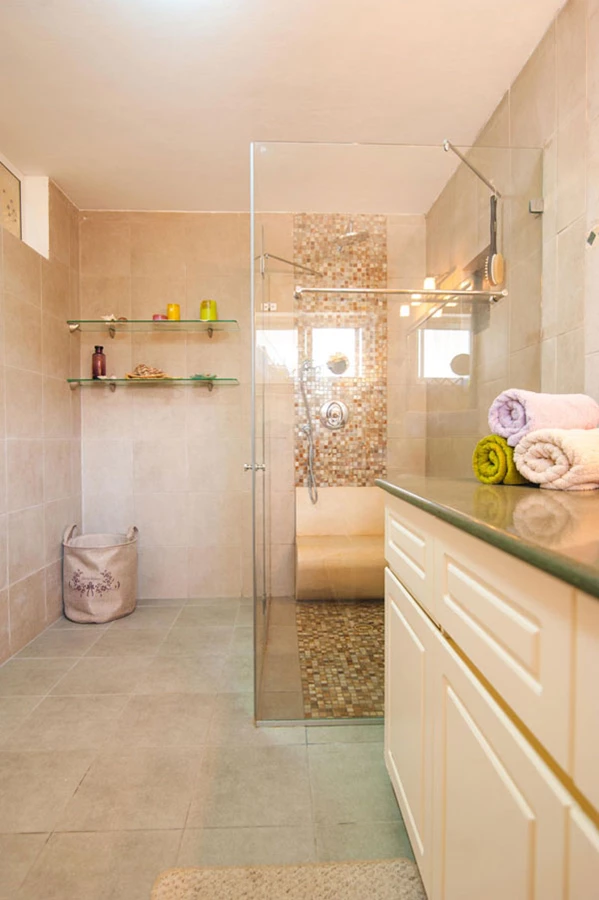 מקלחון מודרני עם ספסל תלוי מאבן